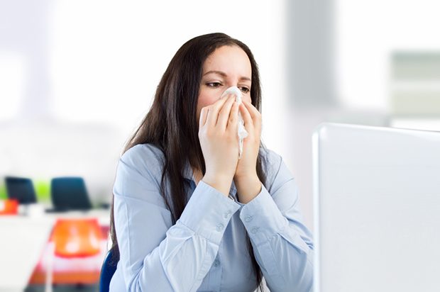 businesswoman with a cold at the office